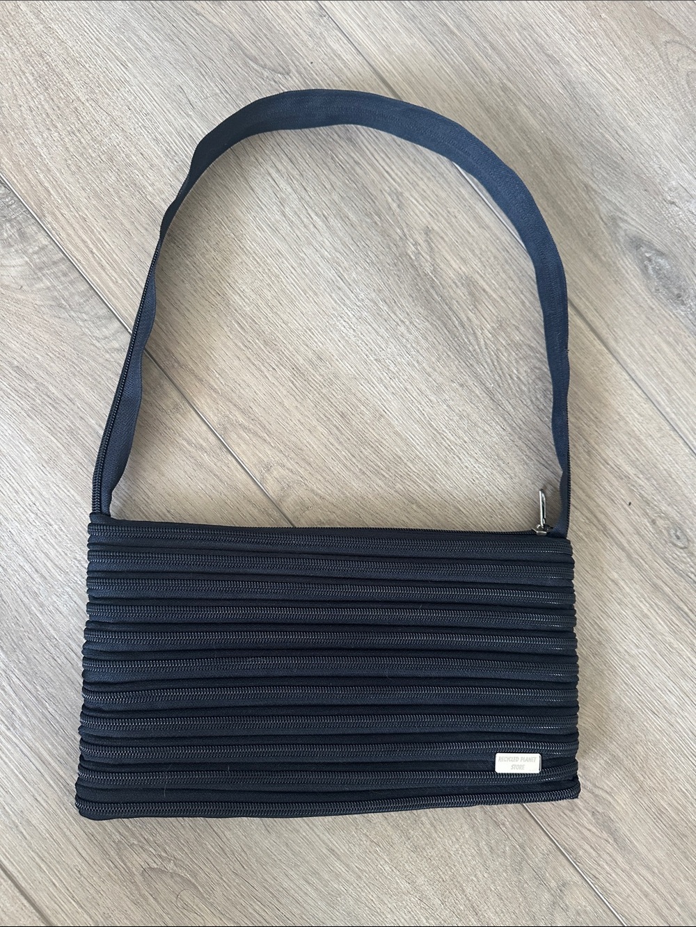 Black zipper purse. Made by Recycled Planet Store.